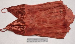 a red, blood-soaked camisole with a Spanish brand label