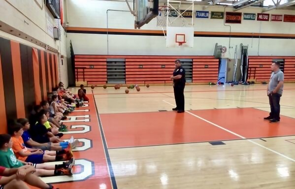 Deputy Chief Devine talking to kids at the DA's basketball camp in Stoughton this morning